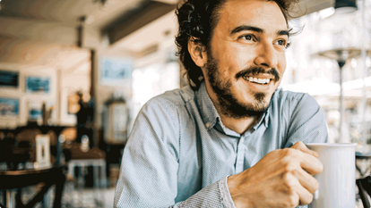 Man drinking coffee in a cafe
