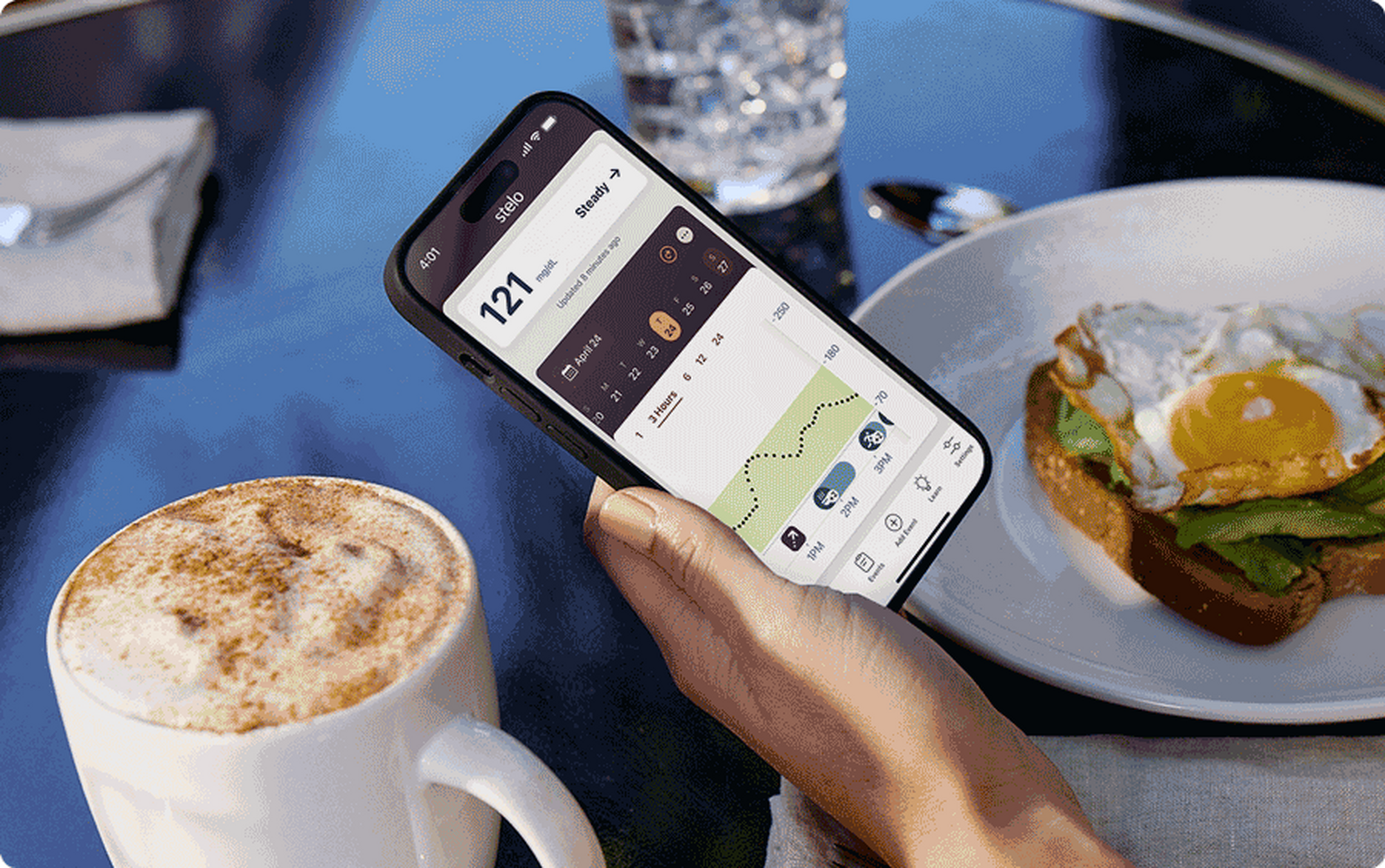 checking glucose readings on phone while eating breakfast