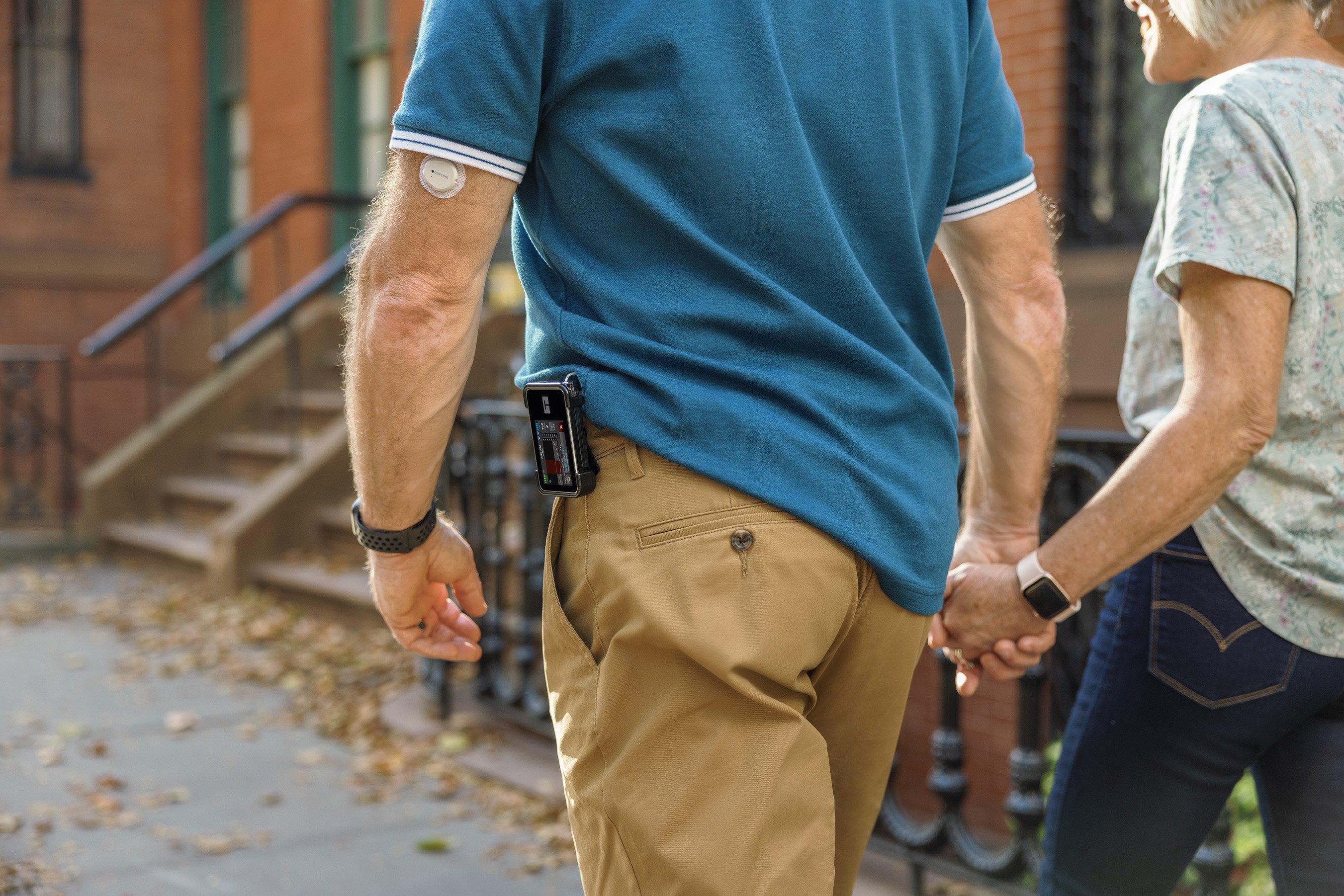 older couple walking using insulin delivery systems