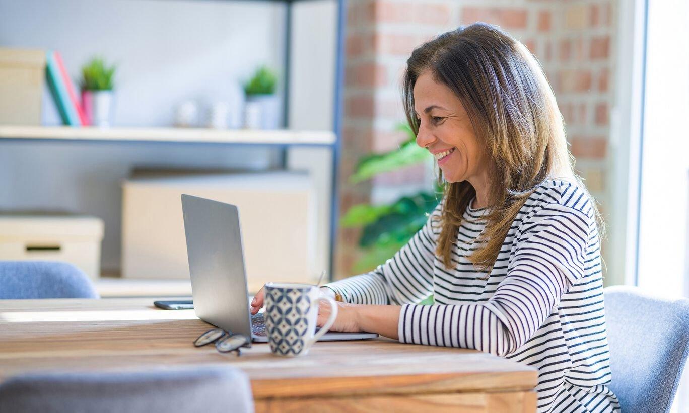 Woman sitting at table with laptop
