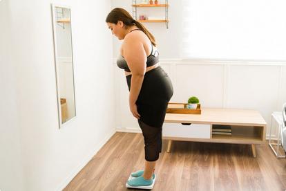 Woman stepping on a scale