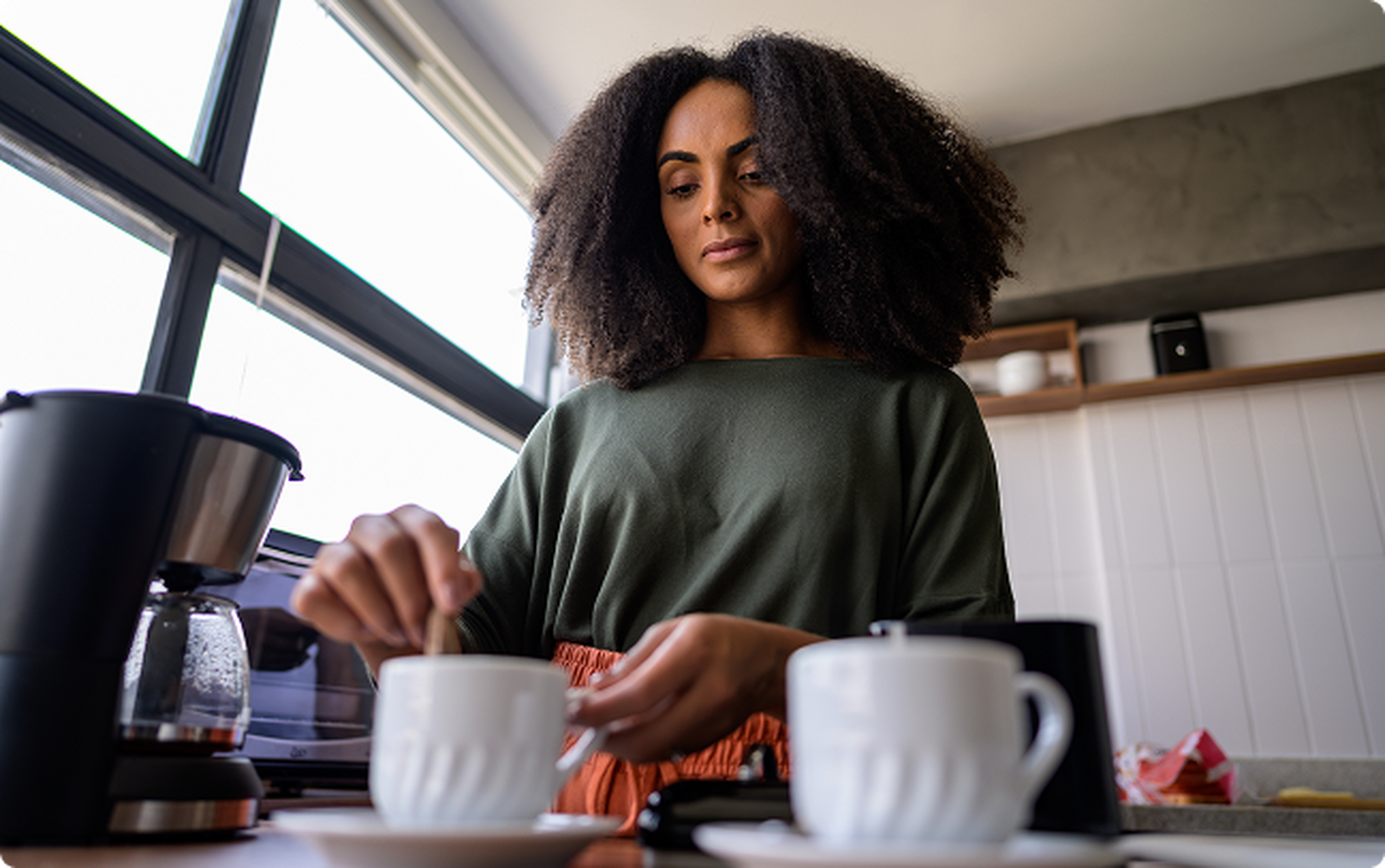 man wearing stelo biosensor drinking water