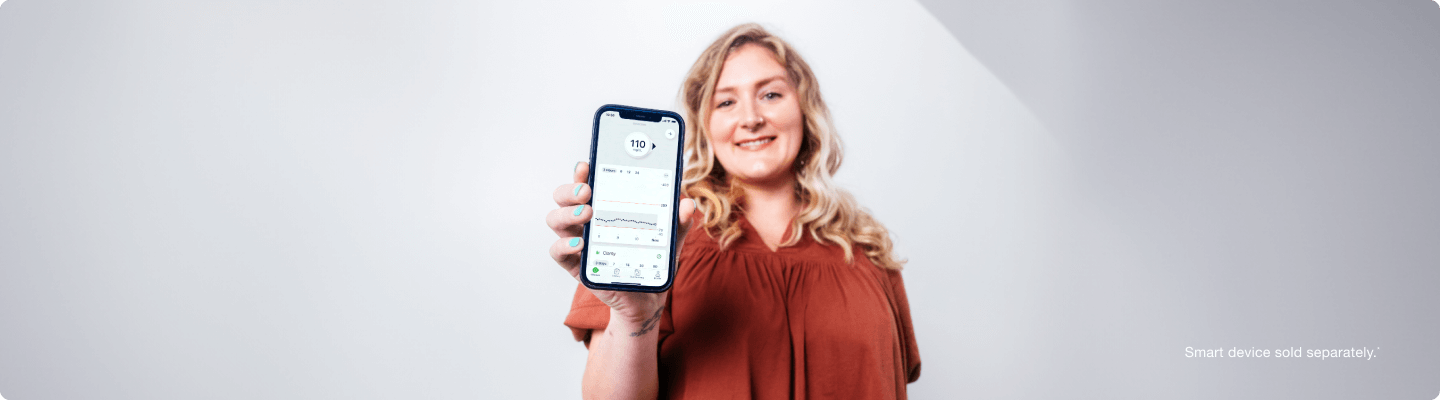 Krista showing her glucose levels on the Dexcom app - Smart device sold separately.*