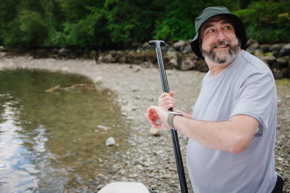 Man checking his glucose on the beach 