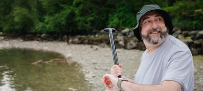 Man checking his glucose on the beach