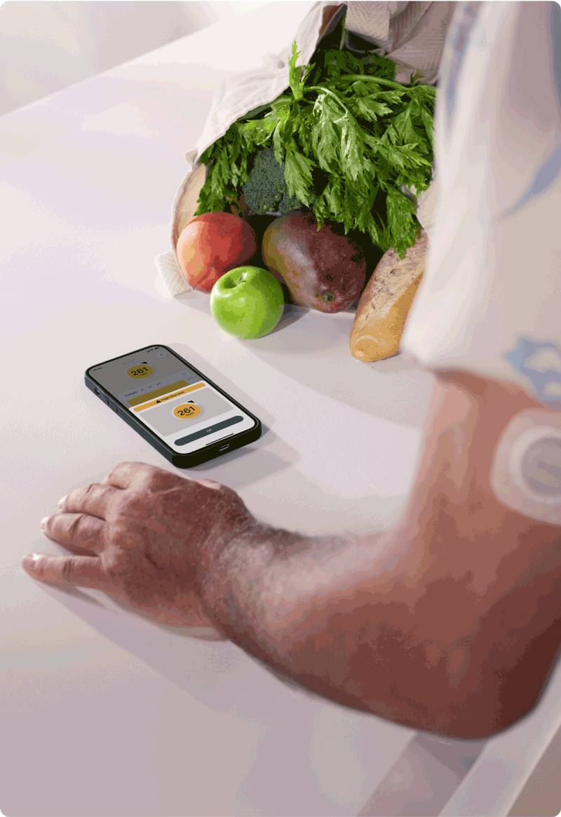 Smart device with dexcom app next to a bag of fresh produce for managing ketoacidosis