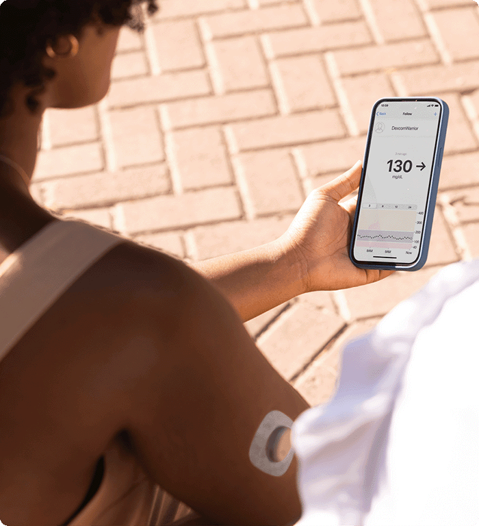 Dexcom warrior checking sharing her glucose data through the Dexcom CGM app