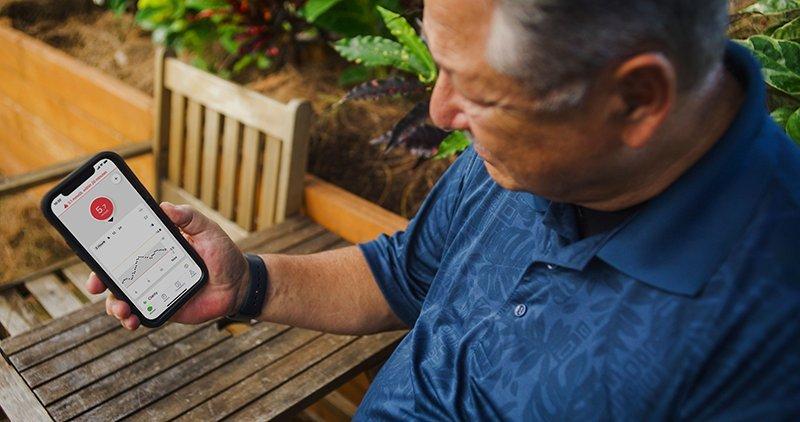 Man observing his glucose readings on a Dexcom G7