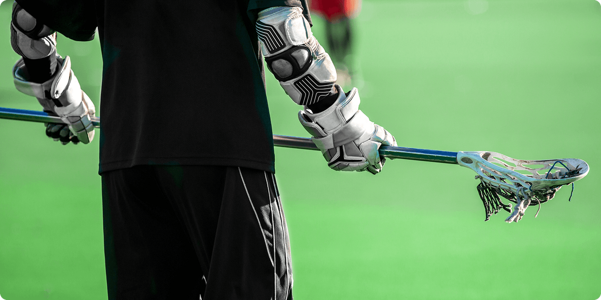 Dexcom U Athlete holding lacrosse stick
