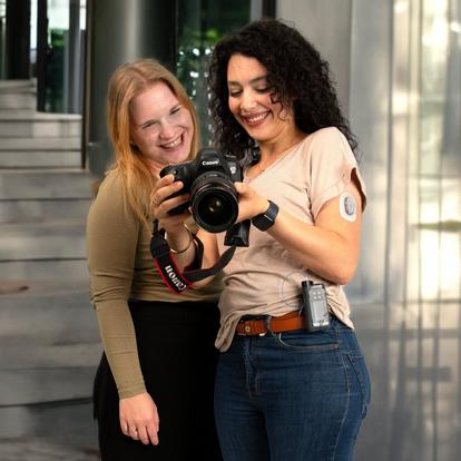 people looking at digital camera with one person wearing the dana and dexcom cgm systems