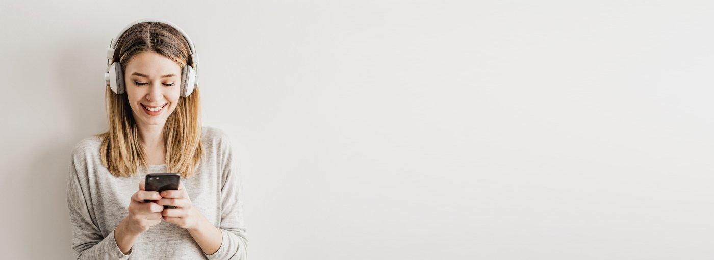 Woman Listening to Podcast smiling