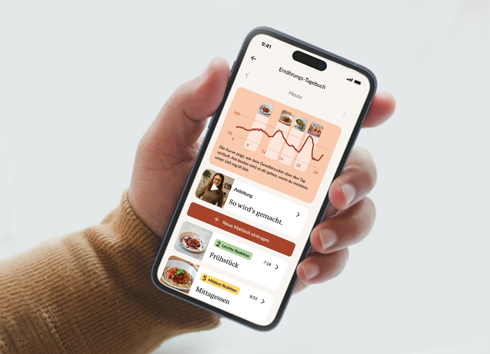 hand holding smartphone and showing the glucura app and how the food has impacted the blood sugars of the user.