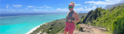 Devon Garrett holding baby bump on the beach