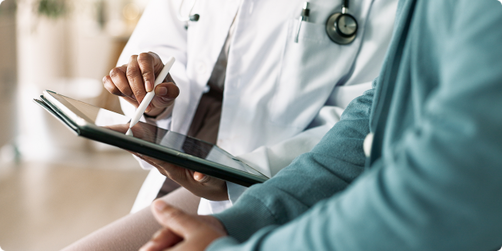 Doctor showing patient something on a tablet