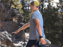 Man stretching wearing Dexcom G7 CGM sesnor on the back of his arm