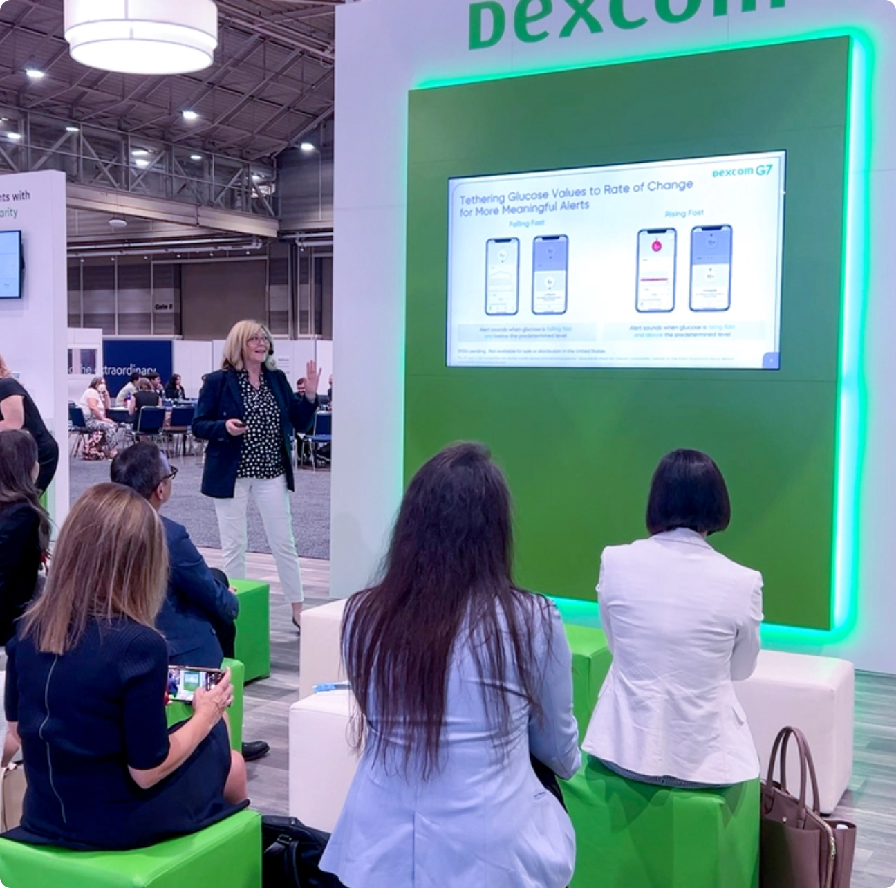 People viewing a in-booth presentation at the show