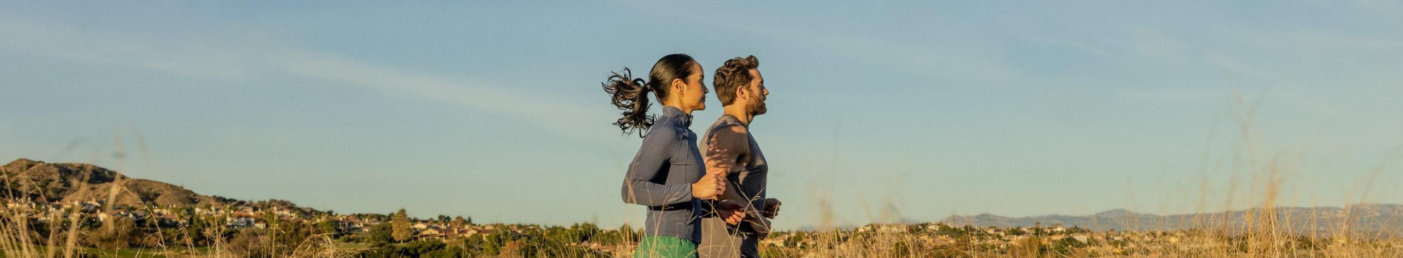 2 people running in a field