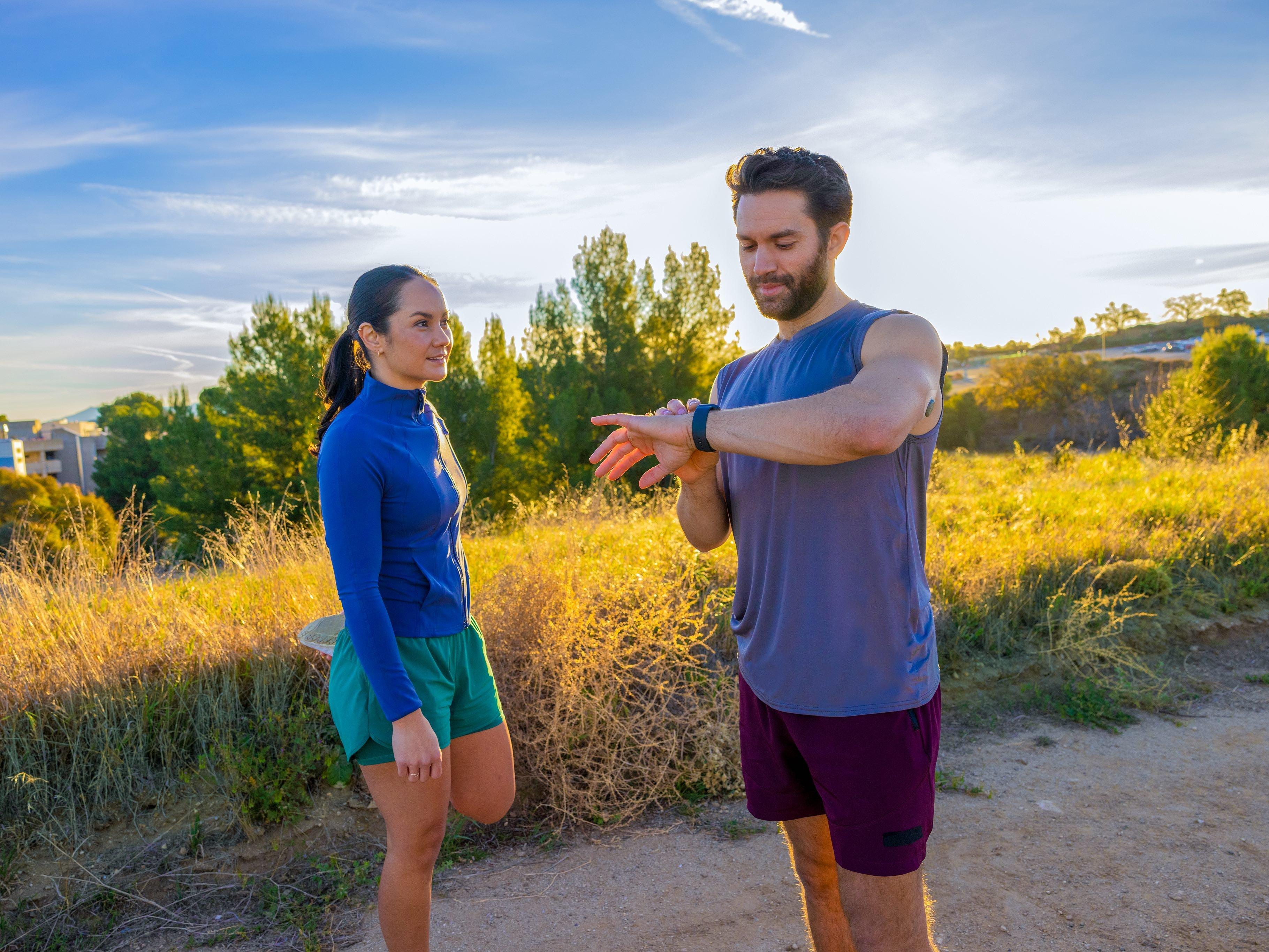 Man and woman stretching outside