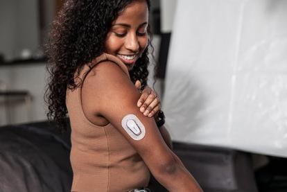 Woman wearing Dexcom CGM with sensor on her arm