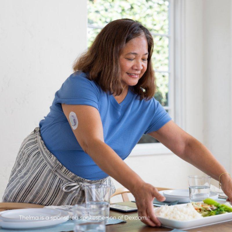 Thelma in blue top setting dinner table