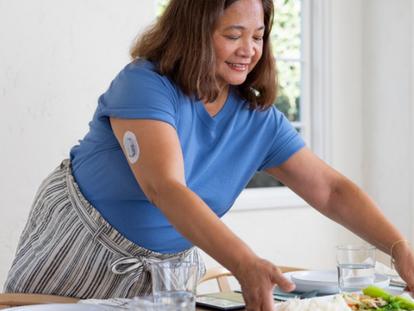 Thelma in blue top setting dinner table