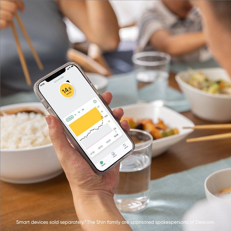 woman at table checking phone app