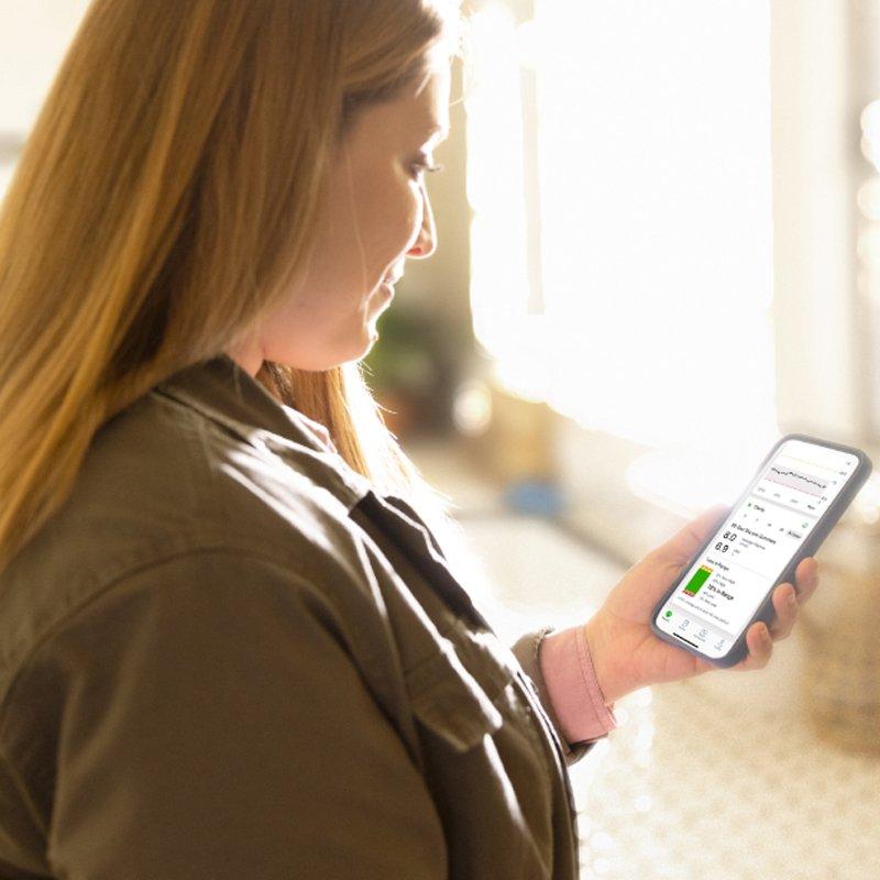 Woman looking at Clarity app on her phone