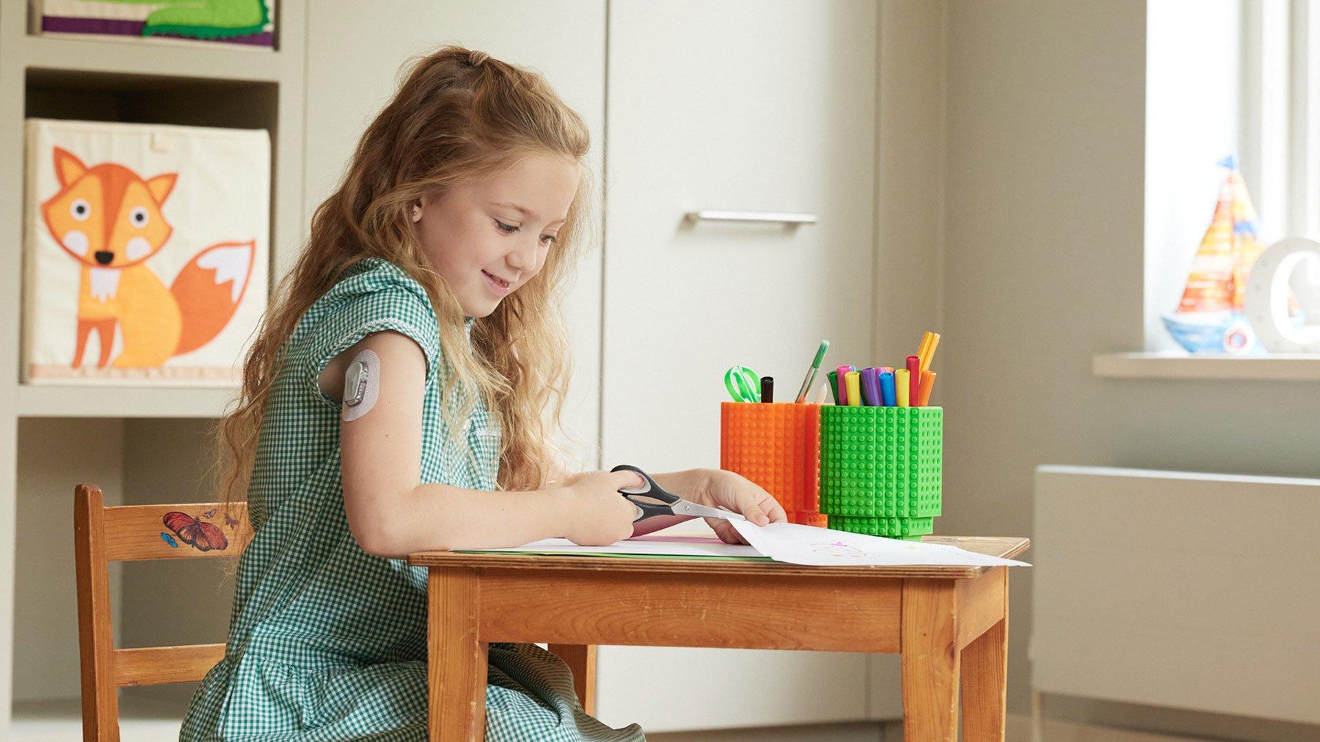 Girl with type 1 diabetes working at school