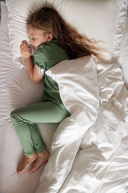 Child with diabetes sleeping with a diabetic patch