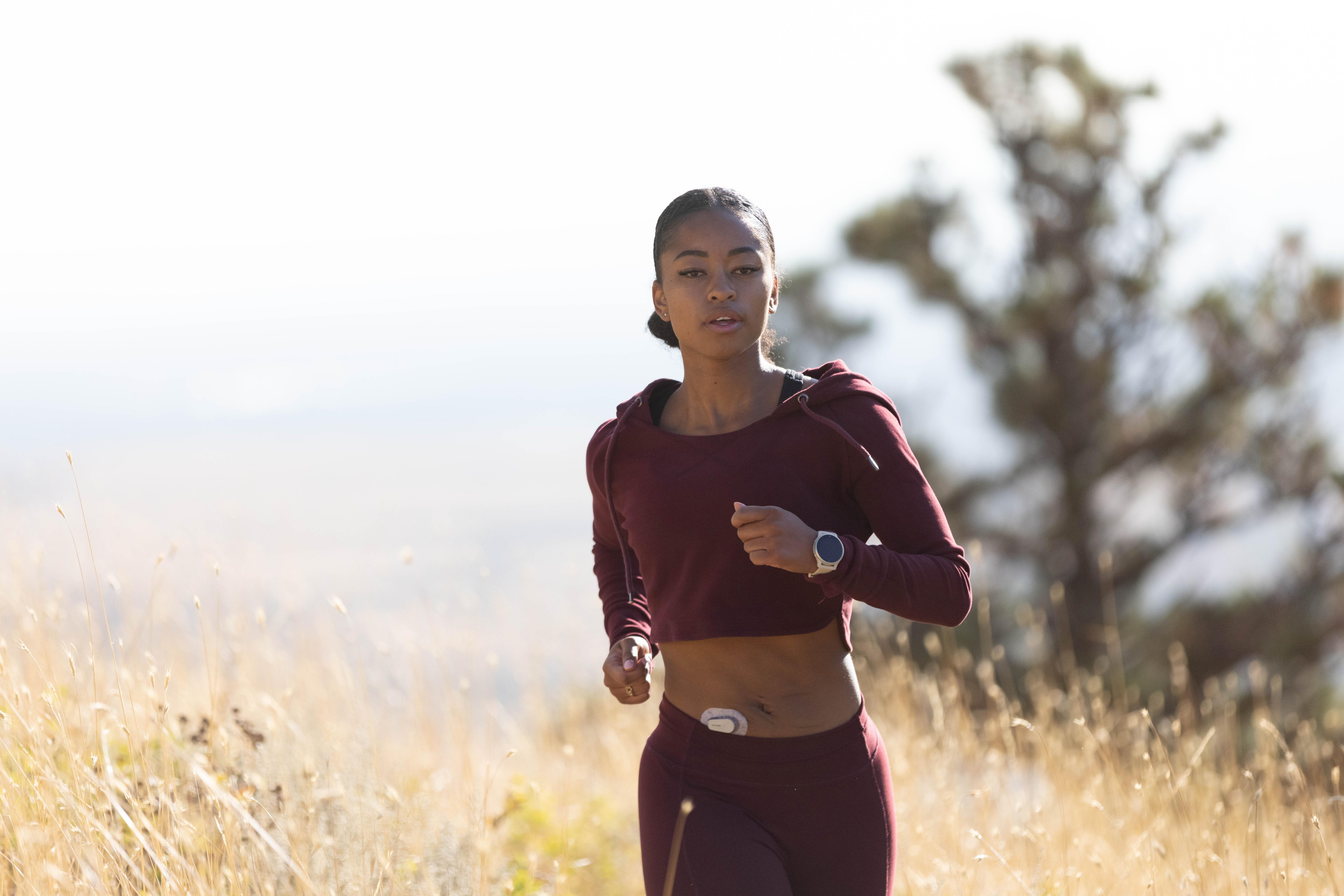 Person jogging wear a Garmin watch using the Dexcom CGM System