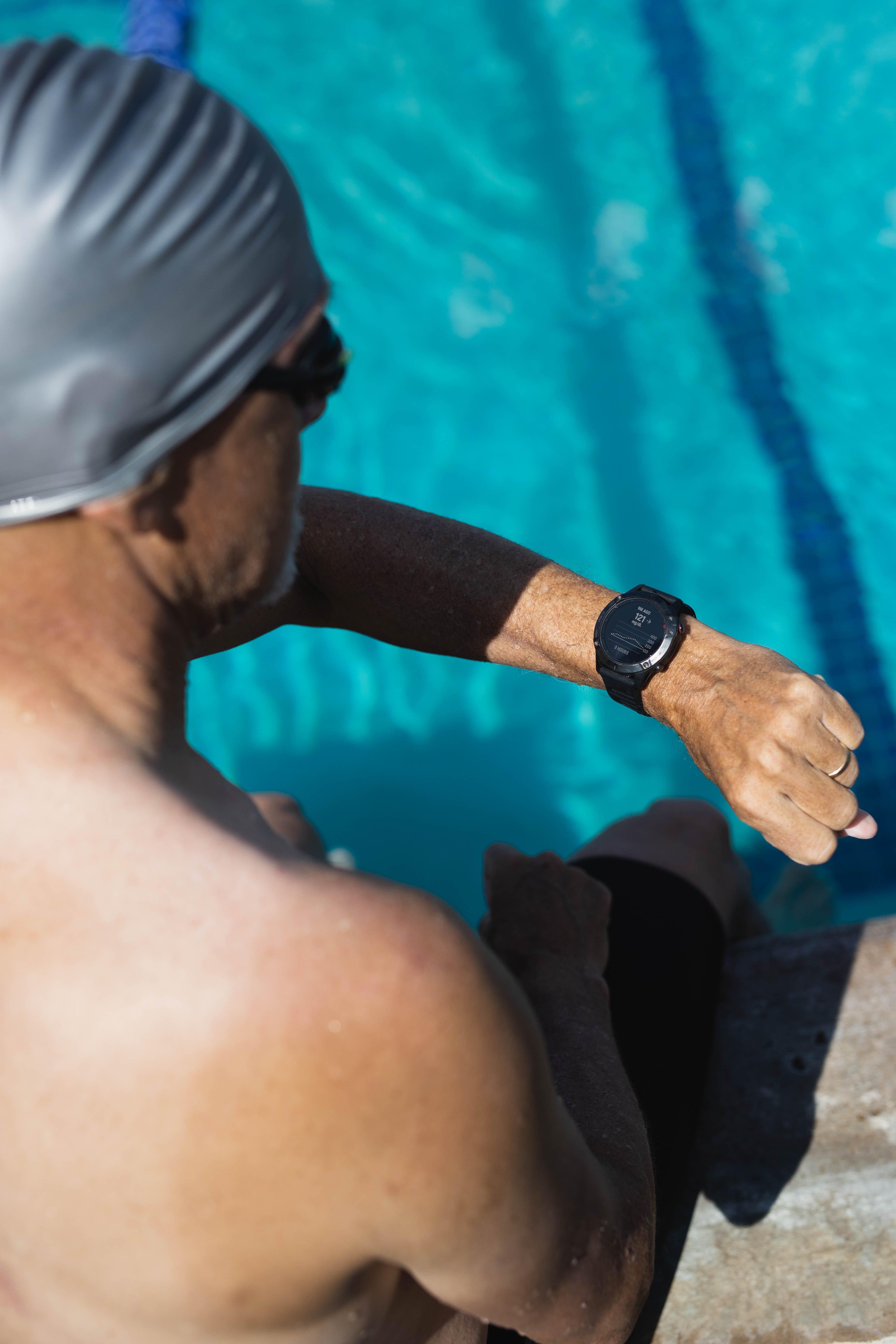 person looking at Garmin watch on arm