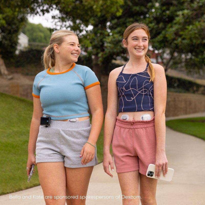 Two female teenagers wearing Dexcom Continous Glucose Monitoring device