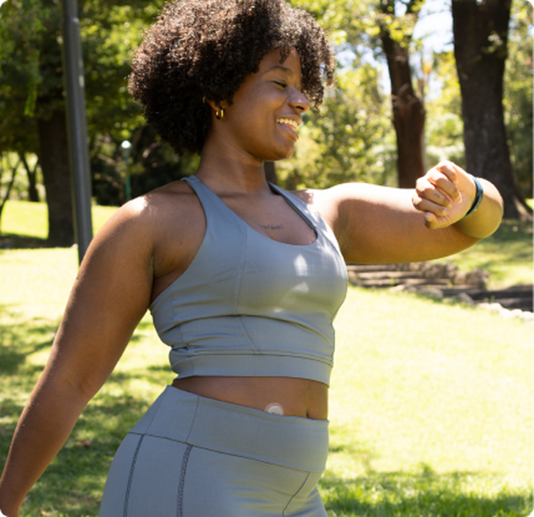 woman checking her glucose on a trail using her smart watch