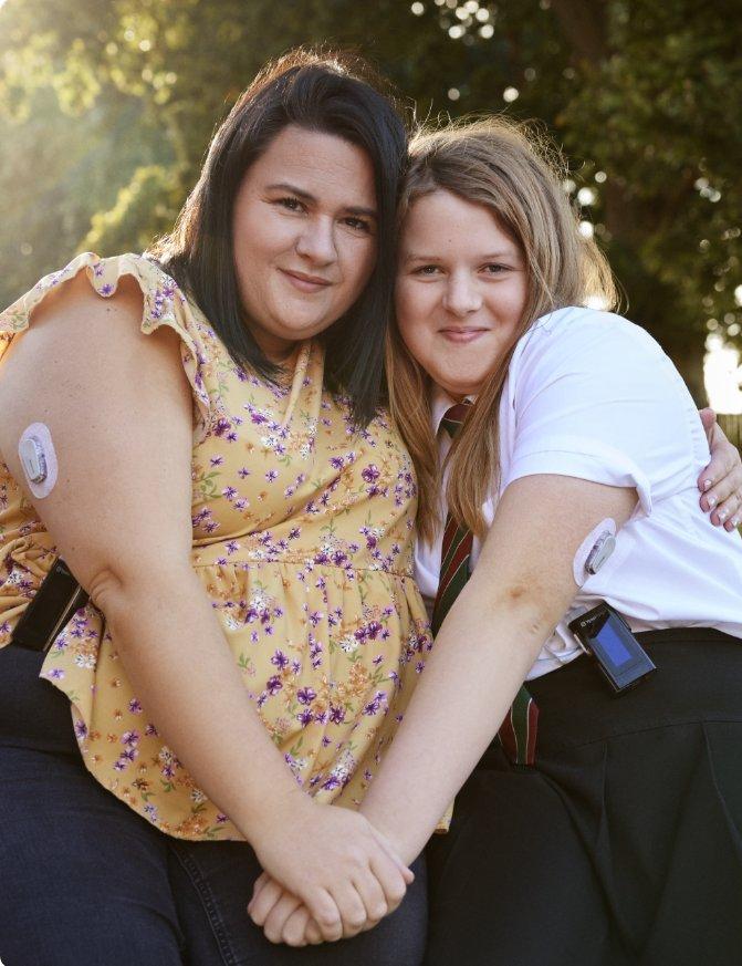 Mother and daughter wearing Dexcom CGM