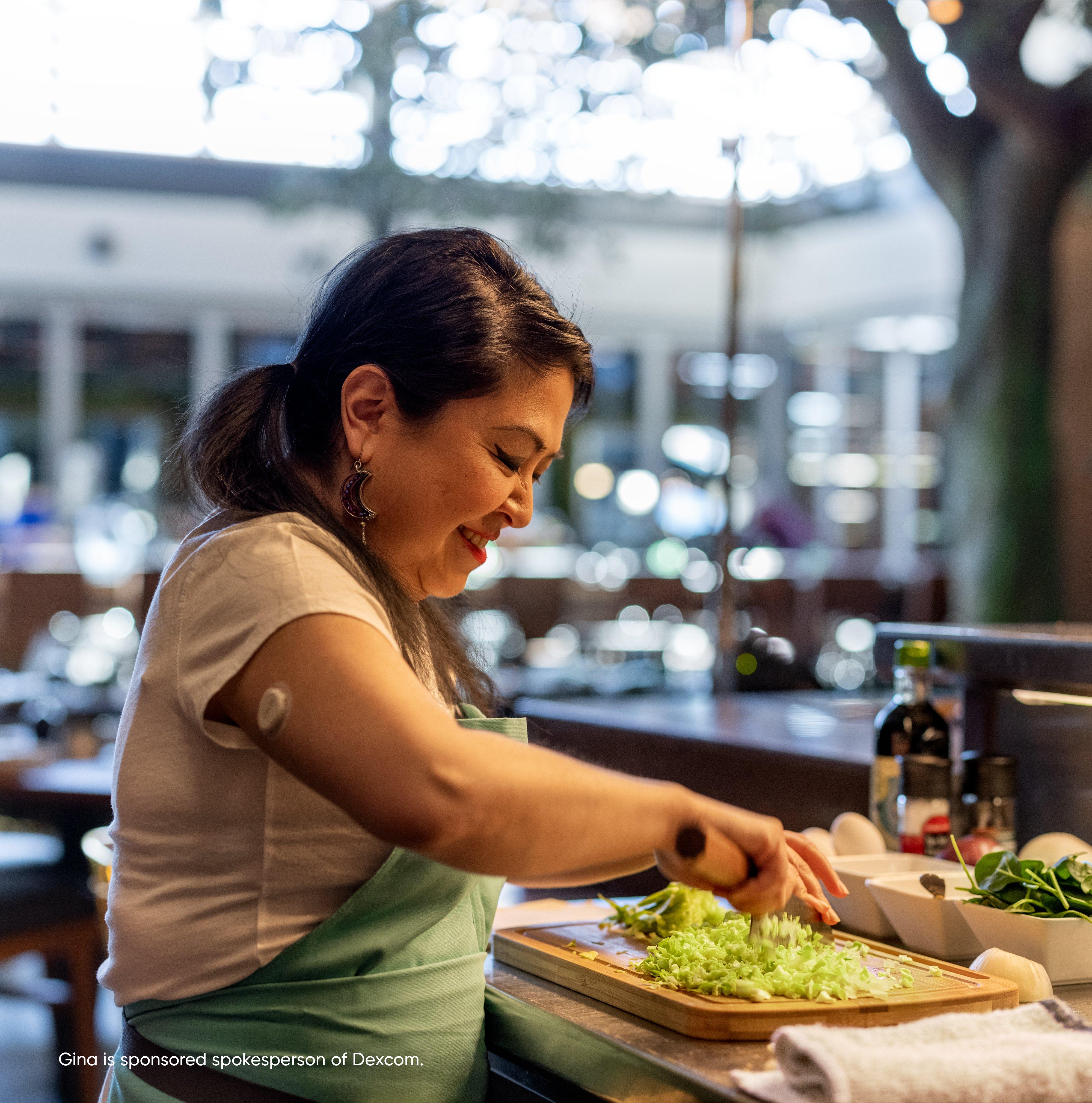 Female chef chopping lettuce wearing Dexcom one device