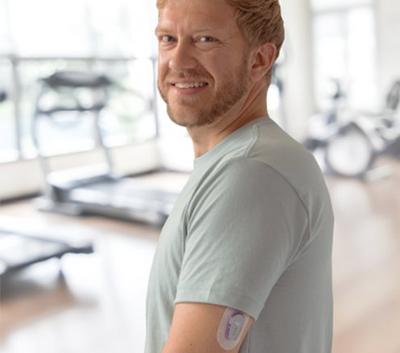 A man with a Dexcom G6 on his upper arm
