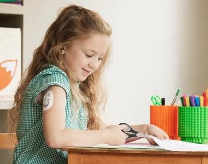 Young girl wearing a Dexcom sensor at school