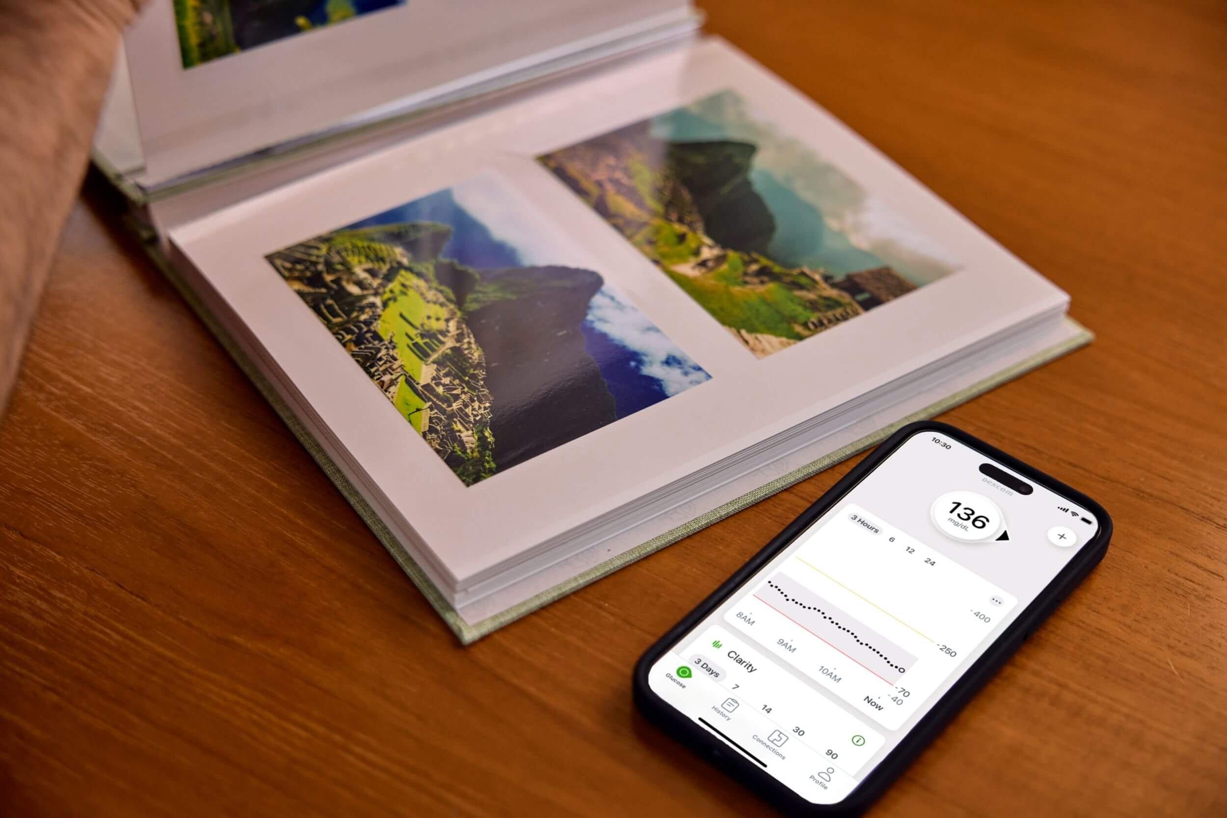 Picture album and phone with readings on the table