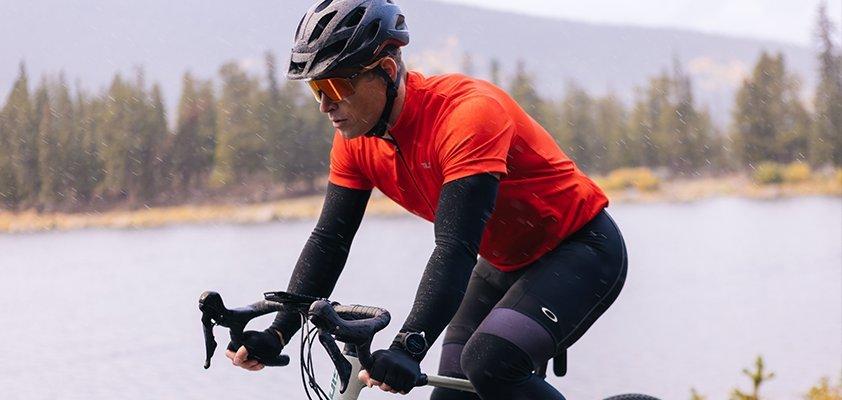 Man riding bike wearing Garmin watch