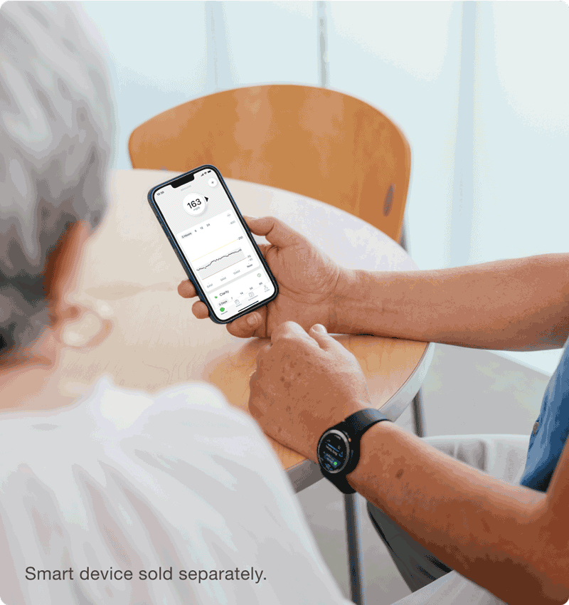 man sitting at table showing readings to a friend