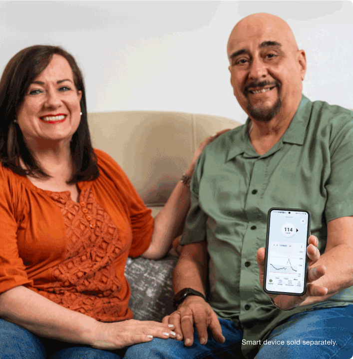 Leo and Annie smiling with showing phone screen