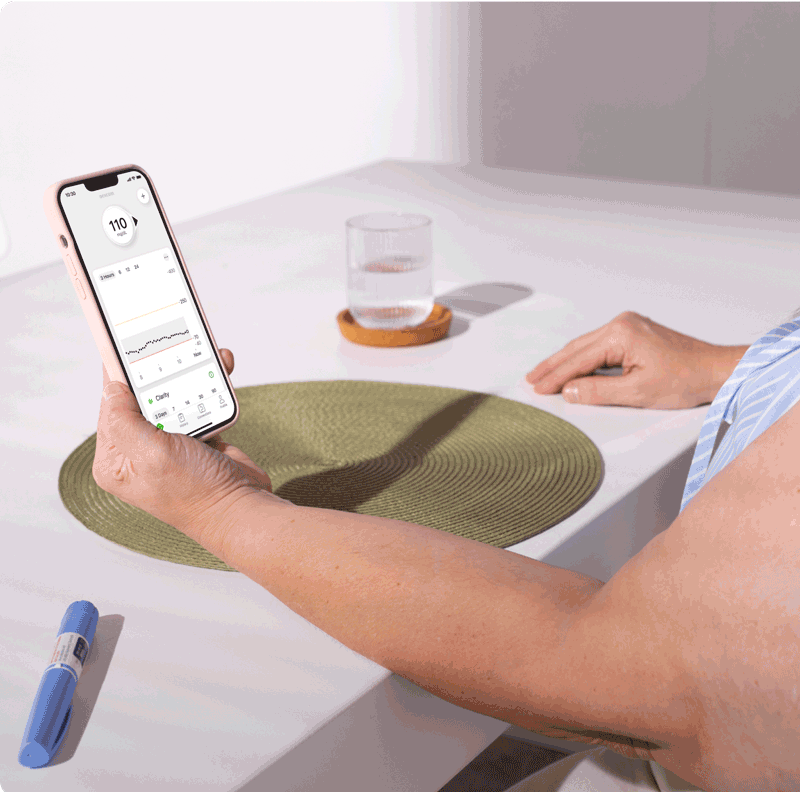 Person checking thier glucose levels with the app