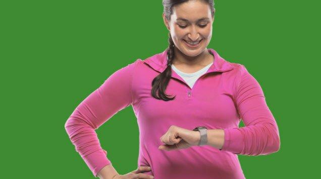 Woman smiling checking her smart watch