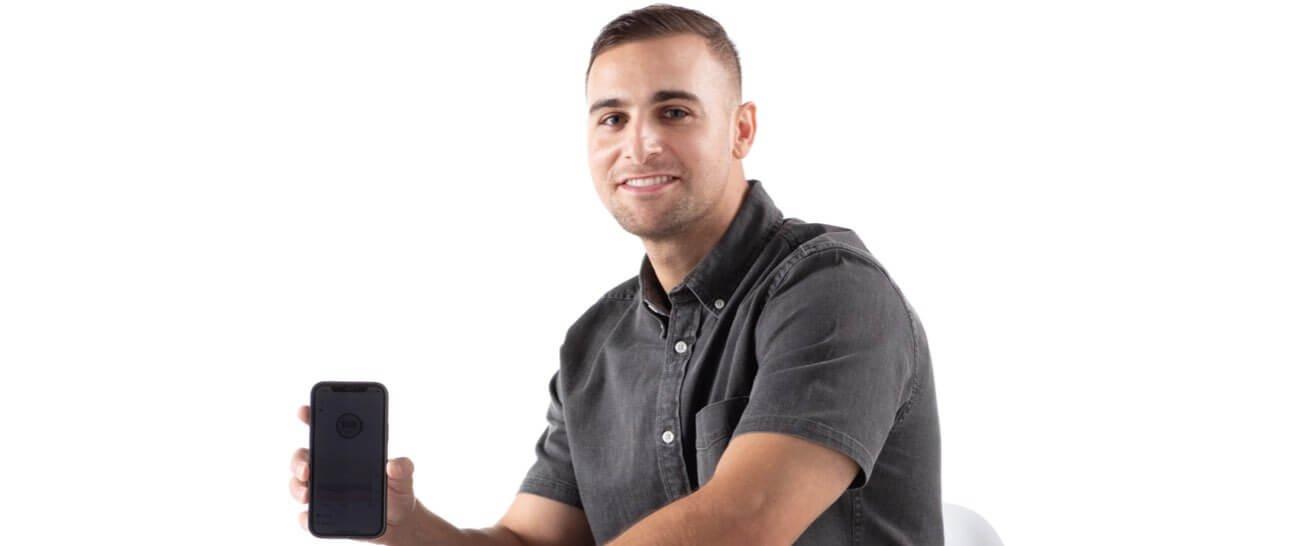Headshot of Pietro holding a phone with the Dexcom g6 app