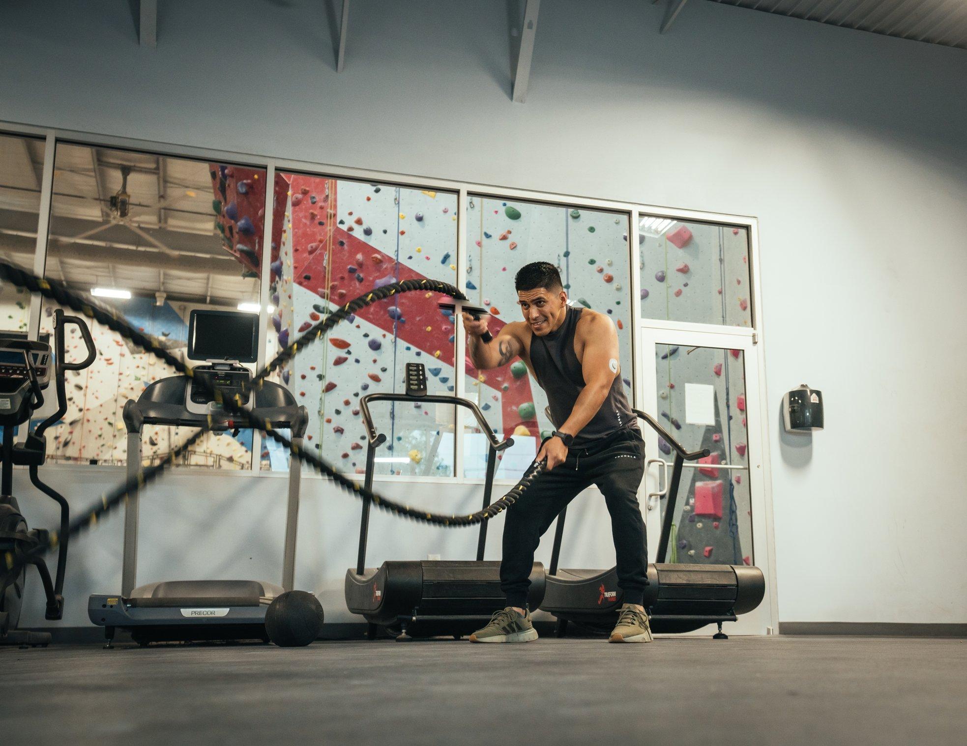 man in gym with ropes wearing dexcom g7 sensor