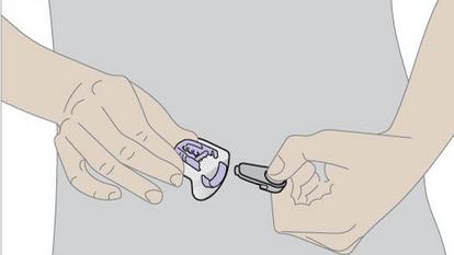 hands pulling transmitter from holder