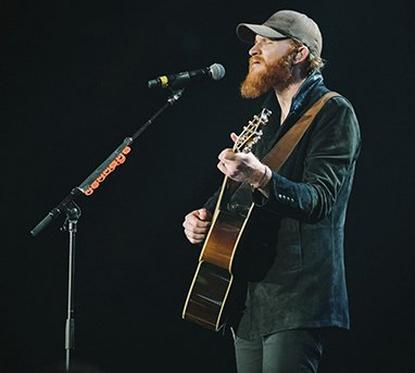 eric performing with guitar