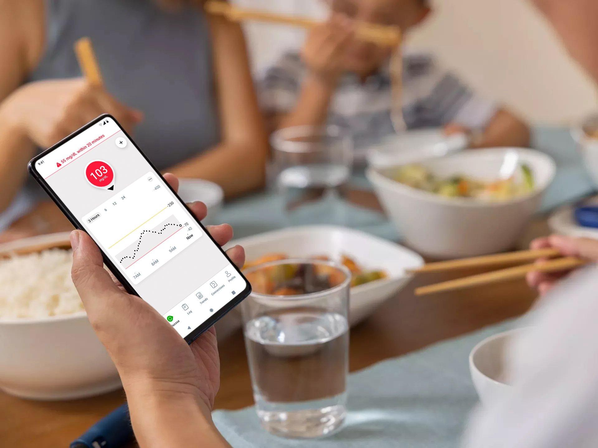 image of a hand holding a smart device with the urgent low message appearing