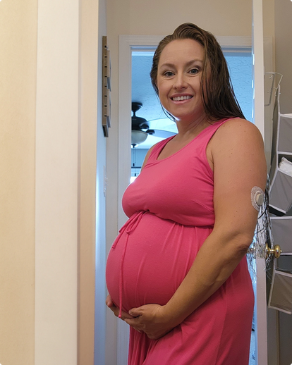 pregnant woman standing smiling