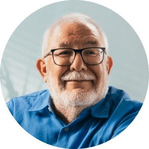 close up of man wearing glasses smiling